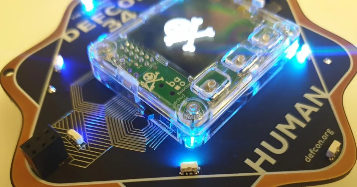 Chip open source Baochip-1x pada badge Defcon 2026 yang dapat diperiksa dengan cahaya inframerah